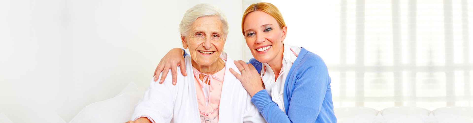 a nurse and an elderly smiling