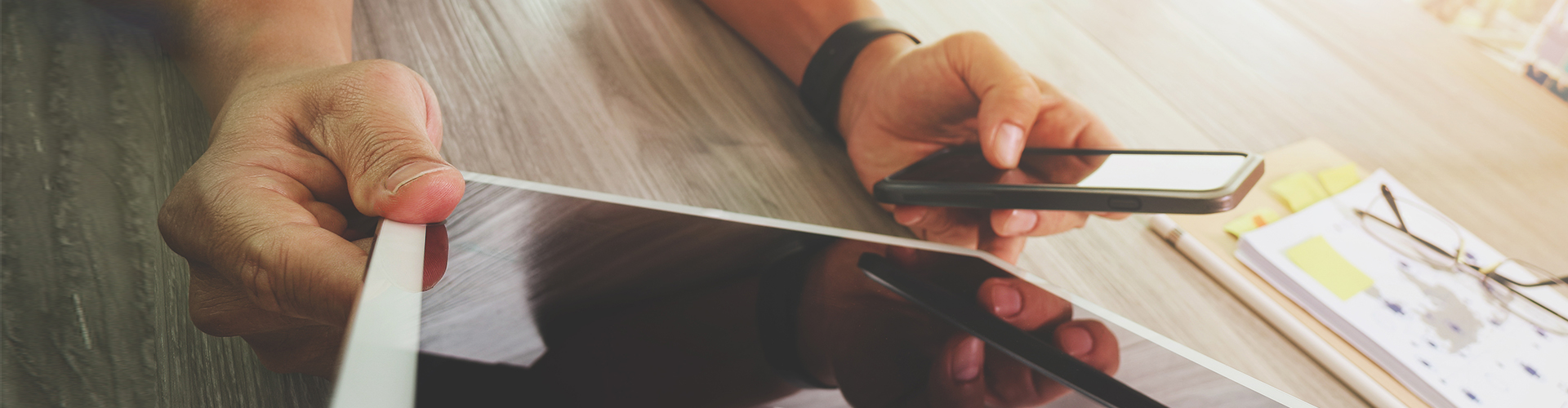 man using tablet and phone