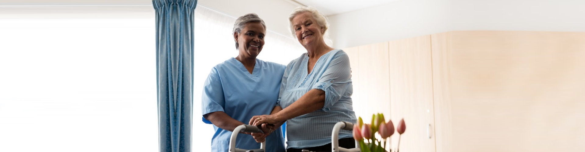 a nurse assisting an elderly with crutches