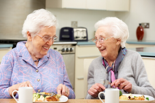 two elderly eating